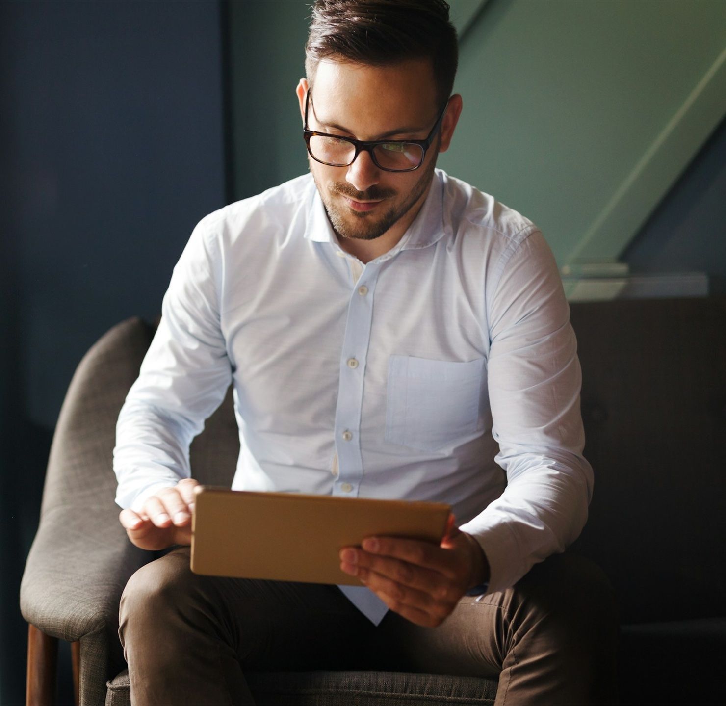 A professional reviewing a document on a tablet