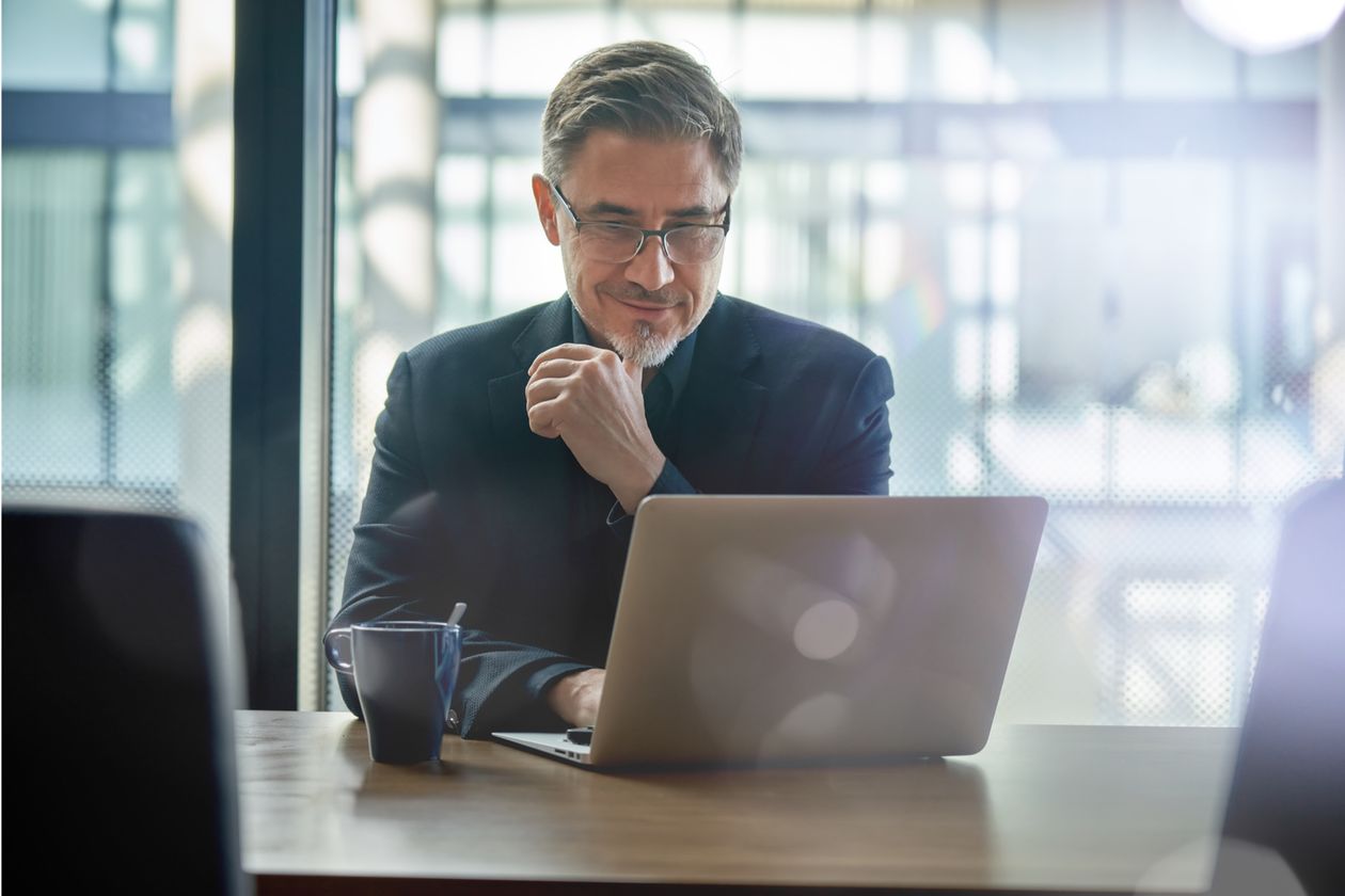 A senior partner reviewing the claim book on a laptop