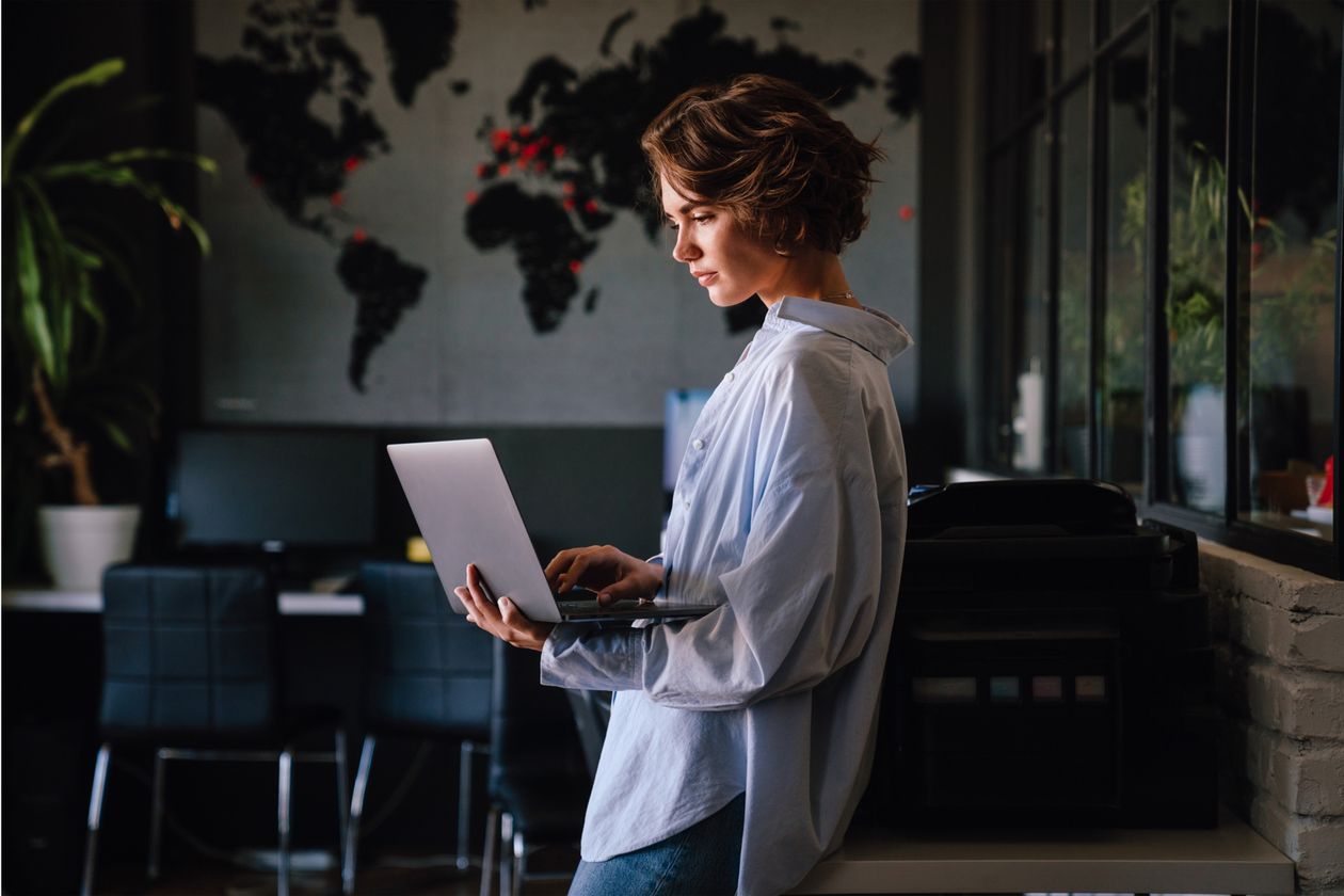 A paralegal working through correspondence on a laptop